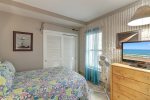 Guest bedroom with full size bed, closet space, and flat panel television